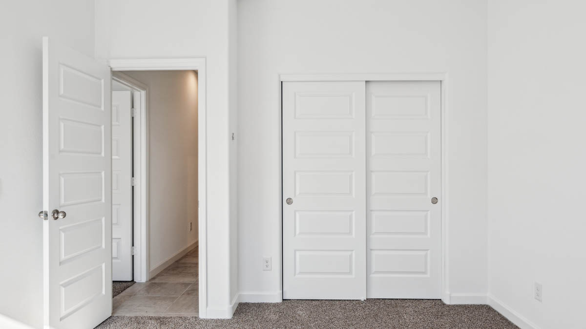 View of the bedroom overlooking the closet and hallway doors