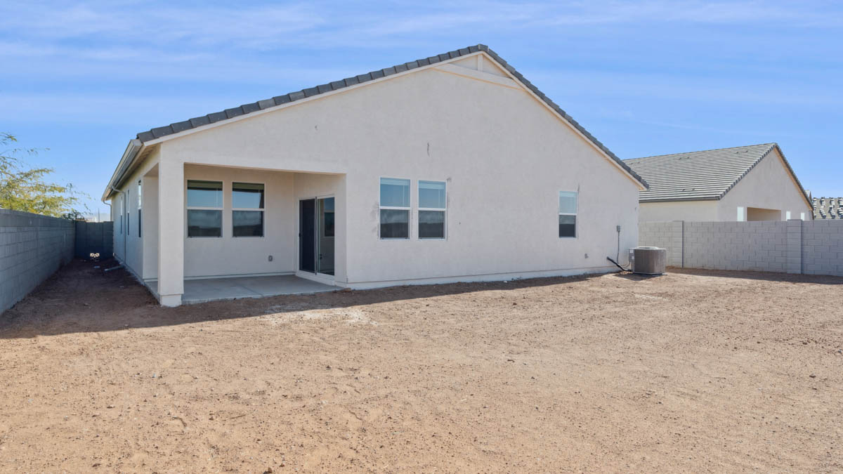 rear exterior of home featuring a spacious fenced in backyard