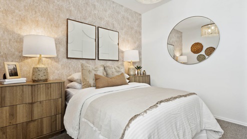 Comfortable guest bedroom featuring neutral-toned walls, carpeted flooring, and a large closet.