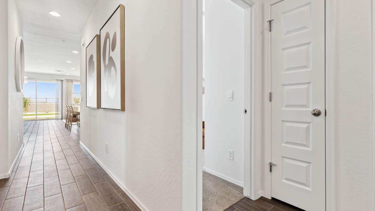 Entry hallway leading to living room and kitchen in the background.