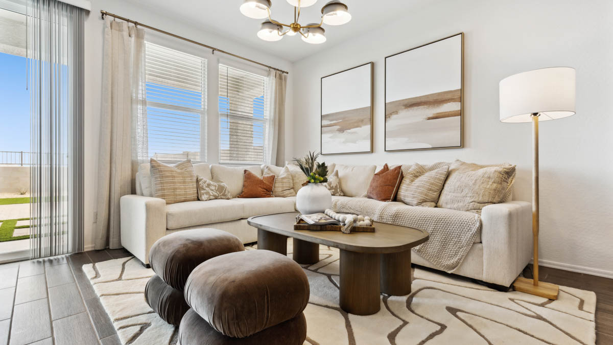 A well-organized living room that includes a kitchen and dining area, creating a warm and welcoming environment for gatherings.