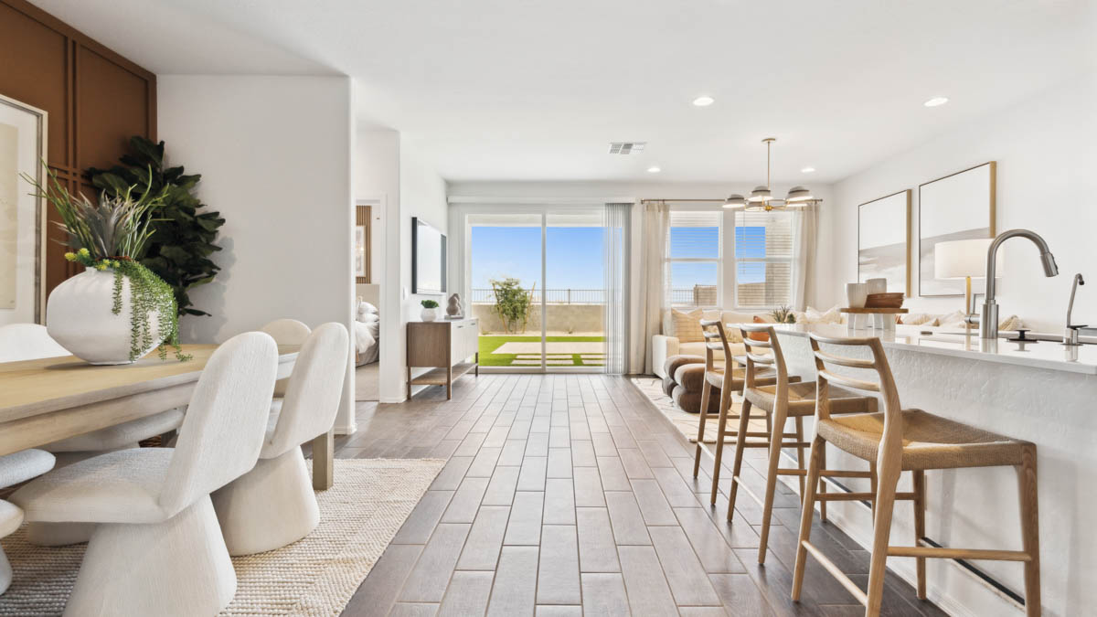 A well-organized living room that includes a kitchen and dining area, creating a warm and welcoming environment for gatherings.