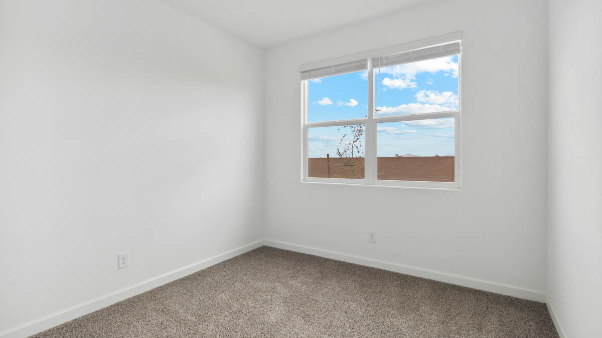 Comfortable guest bedroom featuring neutral-toned walls and a large closet.