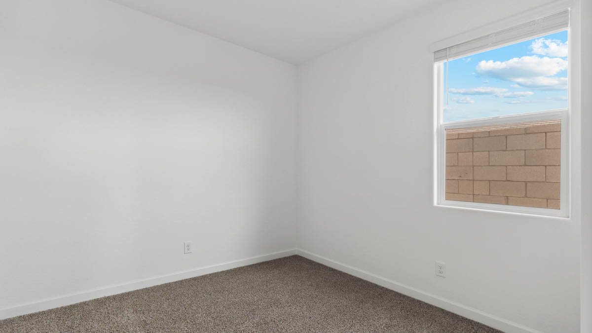 Comfortable guest bedroom featuring neutral-toned walls and a large closet.