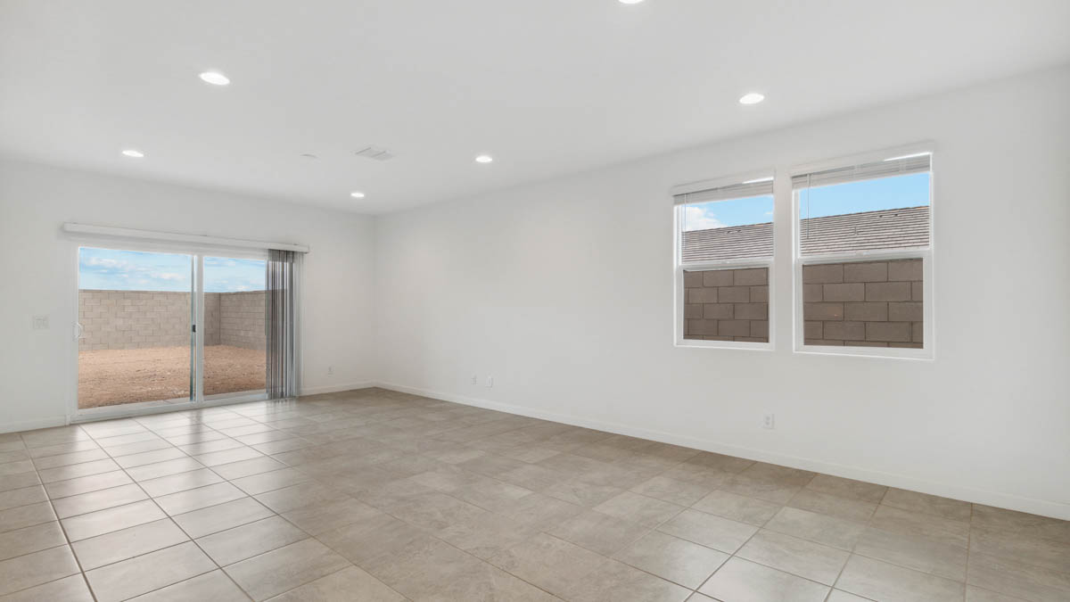 A well-organized living room that includes a kitchen and dining area, creating a warm and welcoming environment for gatherings.