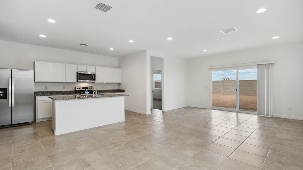 A well-organized living room that includes a kitchen and dining area, creating a warm and welcoming environment for gatherings.