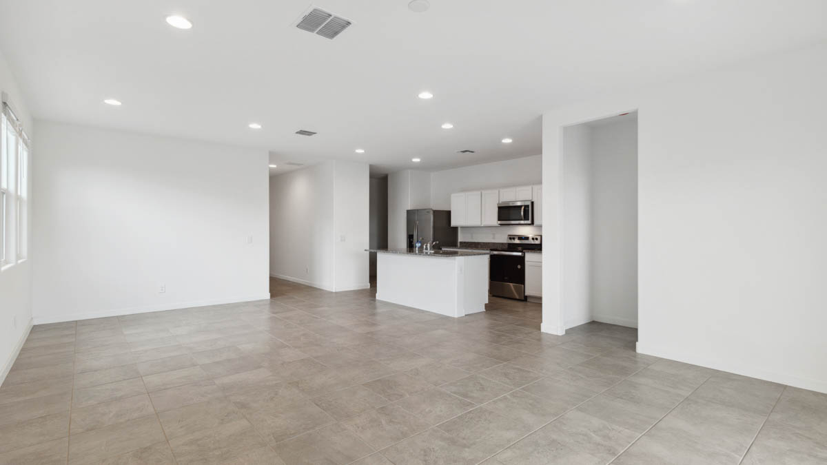 A well-organized living room that includes a kitchen and dining area, creating a warm and welcoming environment for gatherings.