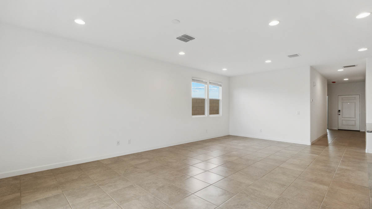 A well-organized living room that includes a kitchen and dining area, creating a warm and welcoming environment for gatherings.