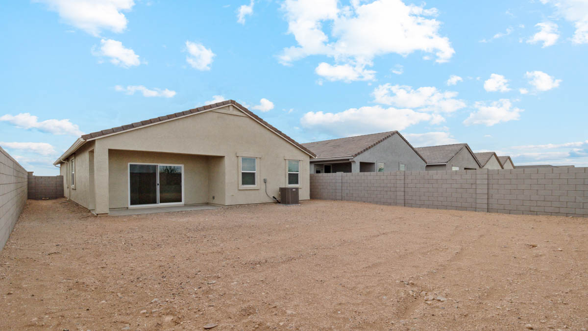Large fenced-in backyard with a covered patio, perfect for outdoor entertaining.