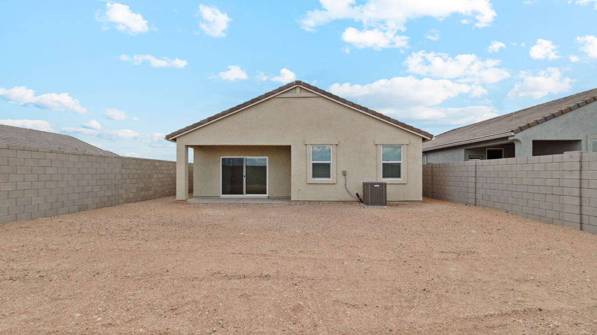 Large fenced-in backyard with a covered patio, perfect for outdoor entertaining.