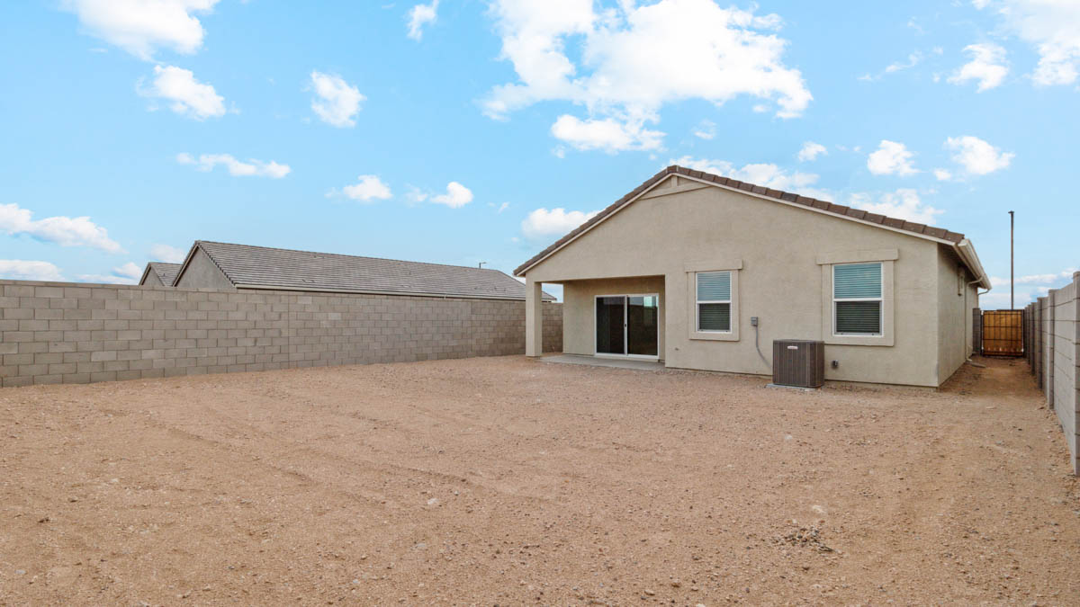 Large fenced-in backyard with a covered patio, perfect for outdoor entertaining.