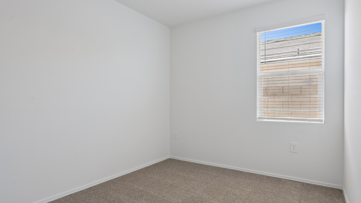 Comfortable guest bedroom featuring neutral-toned walls and a large closet.