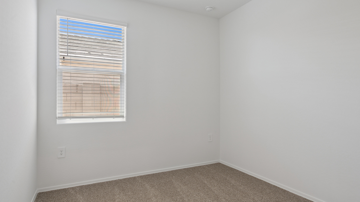 Comfortable guest bedroom featuring neutral-toned walls and a large closet.