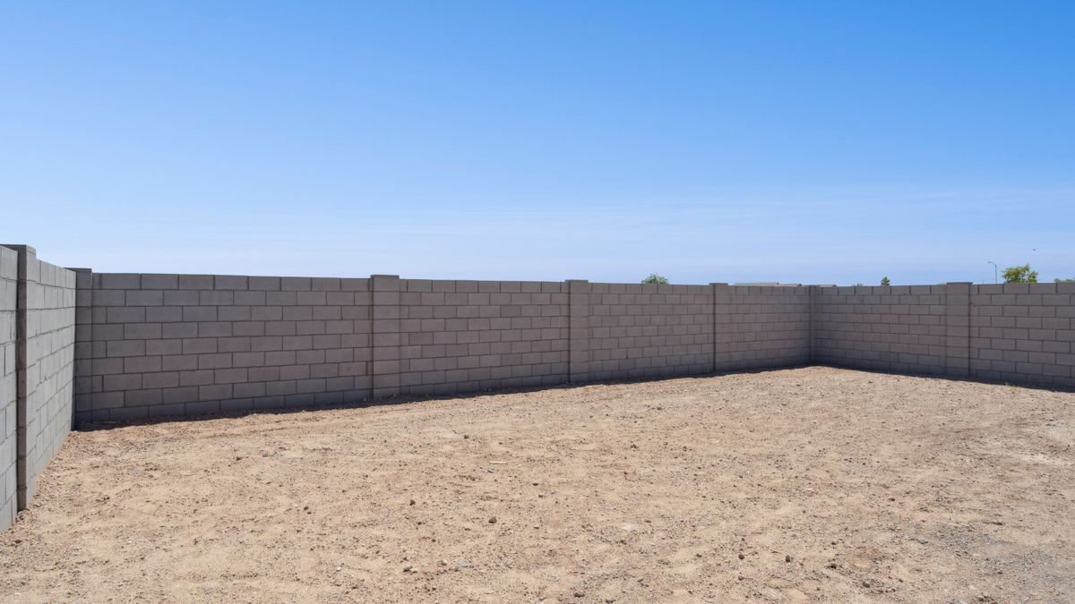 Large fenced-in backyard with a covered patio, perfect for outdoor entertaining.