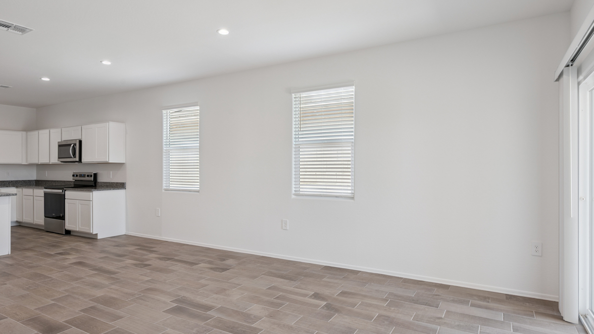 A well-organized living room that includes a kitchen and dining area, creating a warm and welcoming environment for gatherings.