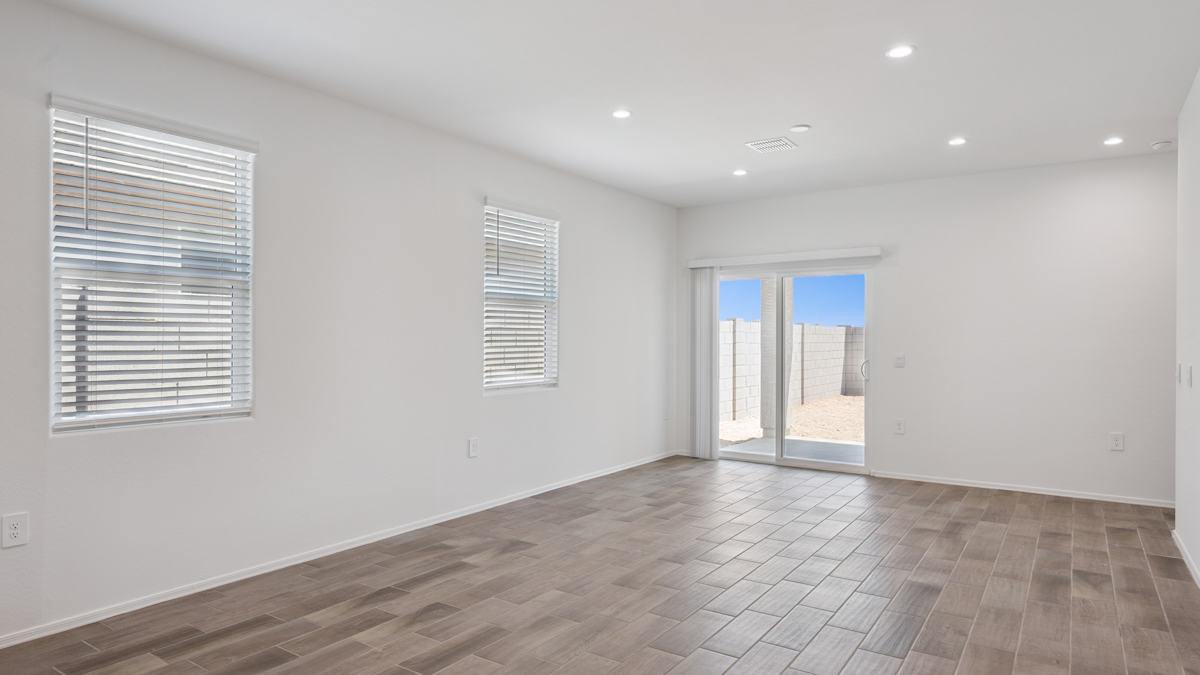 A well-organized living room that includes a kitchen and dining area, creating a warm and welcoming environment for gatherings.