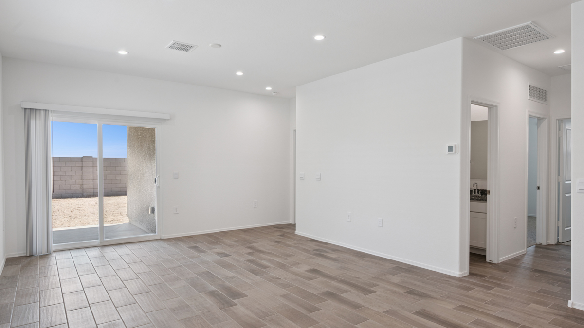 A well-organized living room that includes a kitchen and dining area, creating a warm and welcoming environment for gatherings.