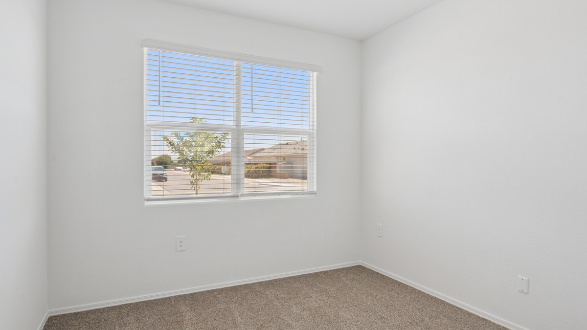 Comfortable guest bedroom featuring neutral-toned walls and a large closet.