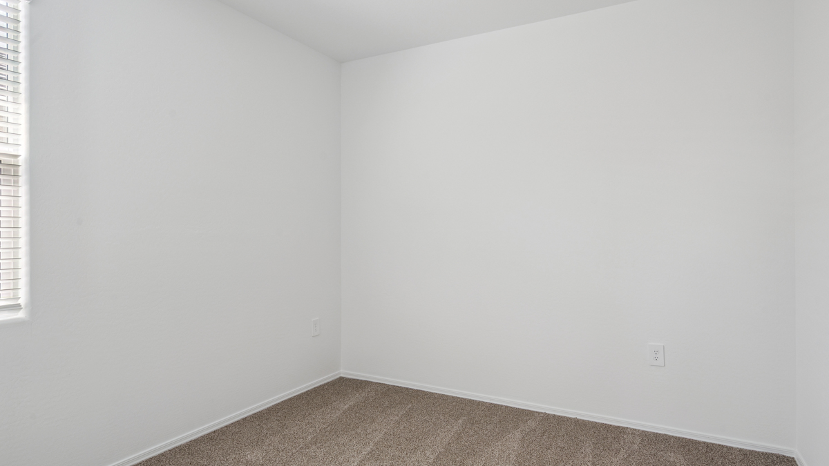 Comfortable guest bedroom featuring neutral-toned walls and a large closet.