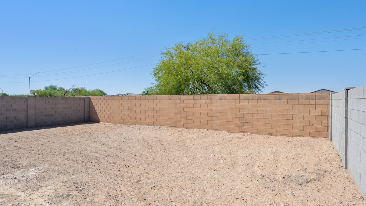 Large fenced-in backyard with a covered patio, perfect for outdoor entertaining.