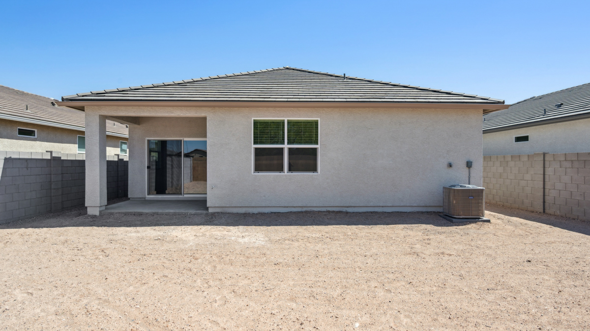 Large fenced-in backyard with a covered patio, perfect for outdoor entertaining.