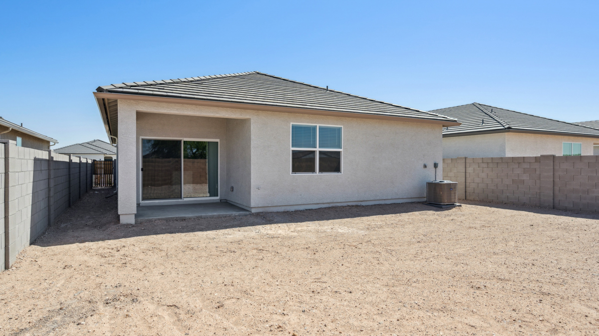 Large fenced-in backyard with a covered patio, perfect for outdoor entertaining.