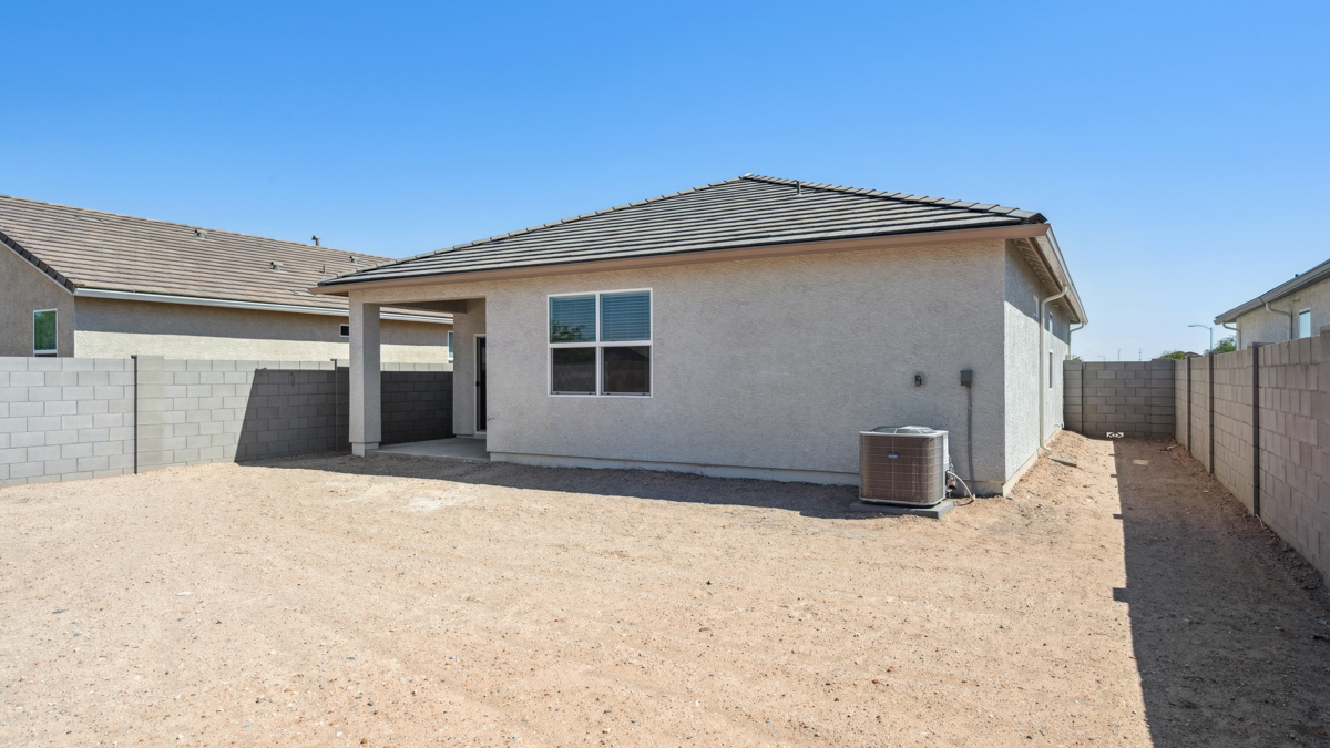 Large fenced-in backyard with a covered patio, perfect for outdoor entertaining.