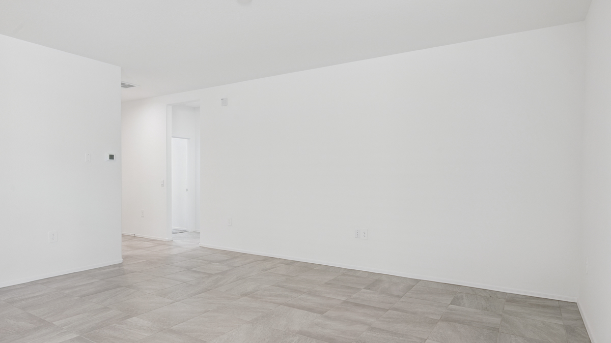 A well-organized living room that includes a kitchen and dining area, creating a warm and welcoming environment for gatherings.