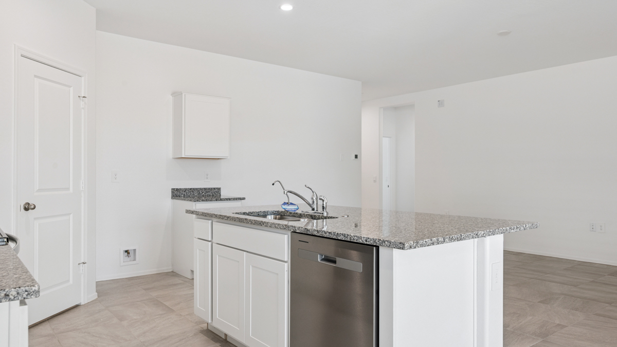 Bright and spacious kitchen with granite countertops, stainless steel appliances, and an island with bar seating.