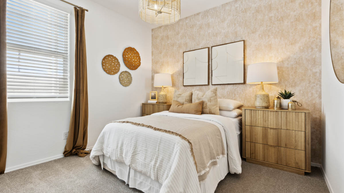 Comfortable guest bedroom featuring neutral-toned walls and a large closet.