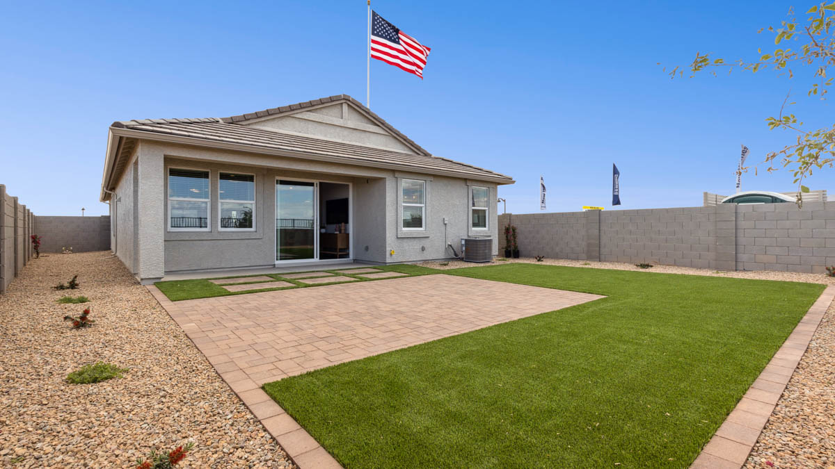 Large fenced-in backyard with a covered patio, perfect for outdoor entertainment.