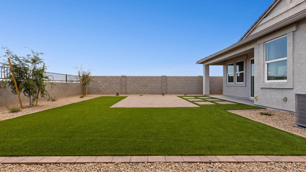 Large fenced-in backyard with a covered patio, perfect for outdoor entertainment.