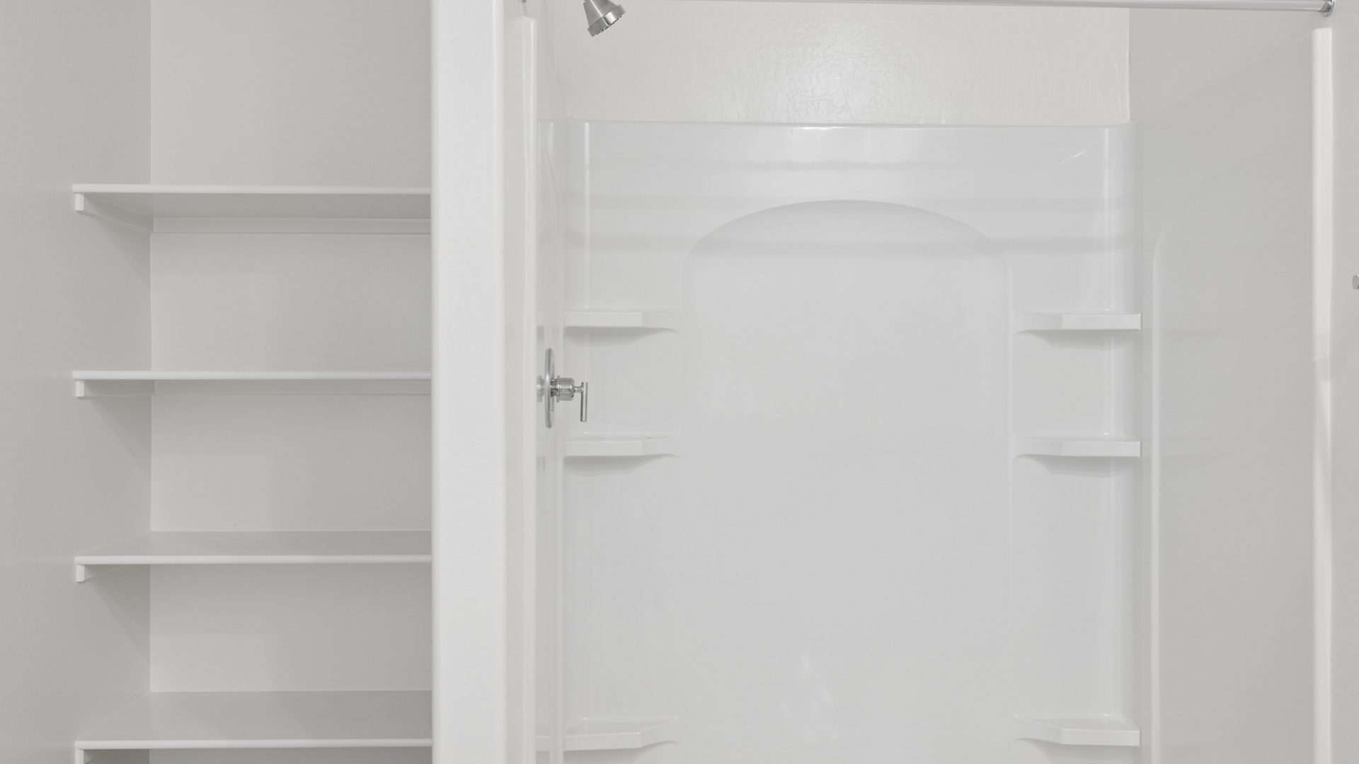 Primary bathroom with dual vanities.