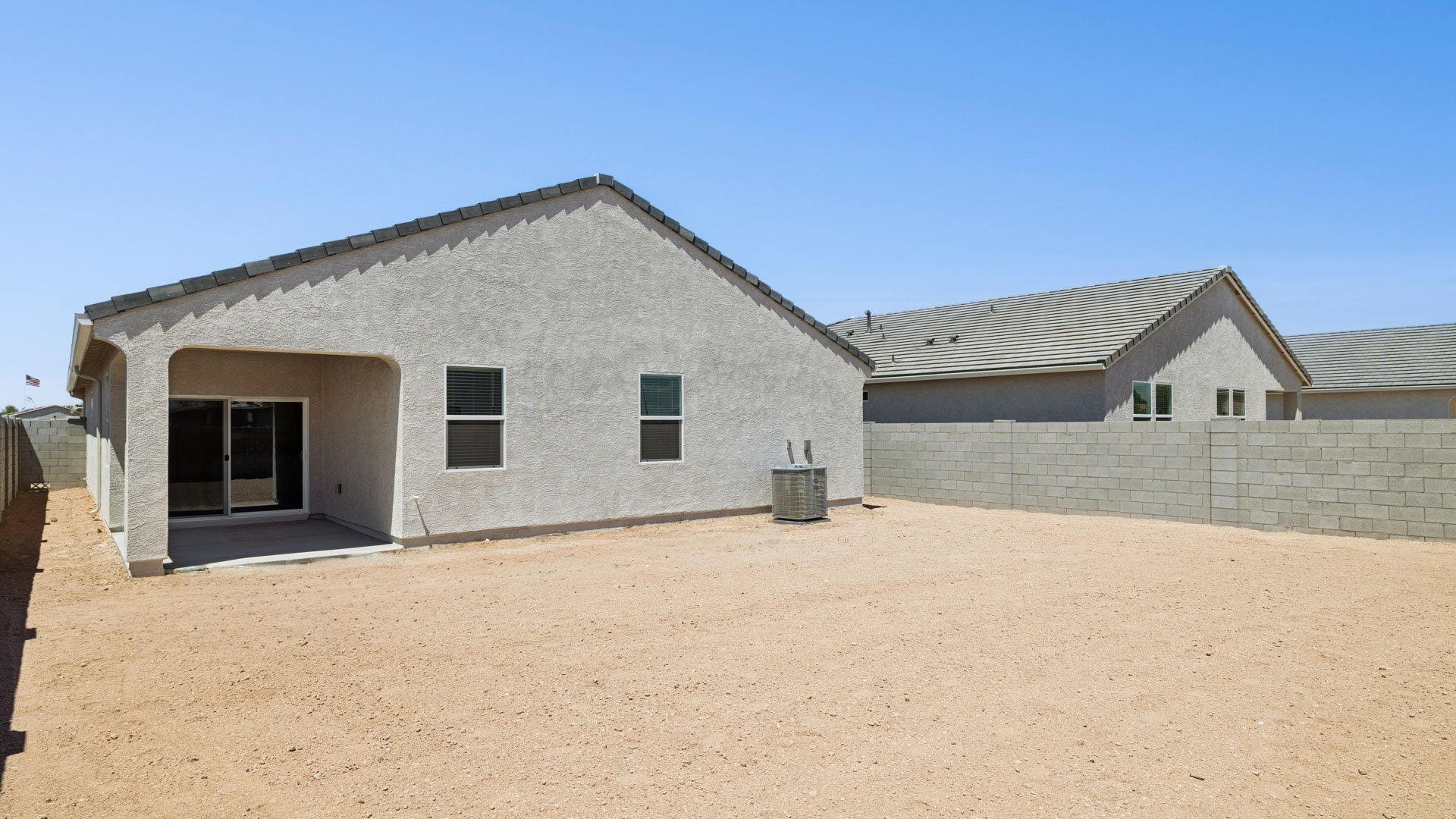 Back of home with covered patio.