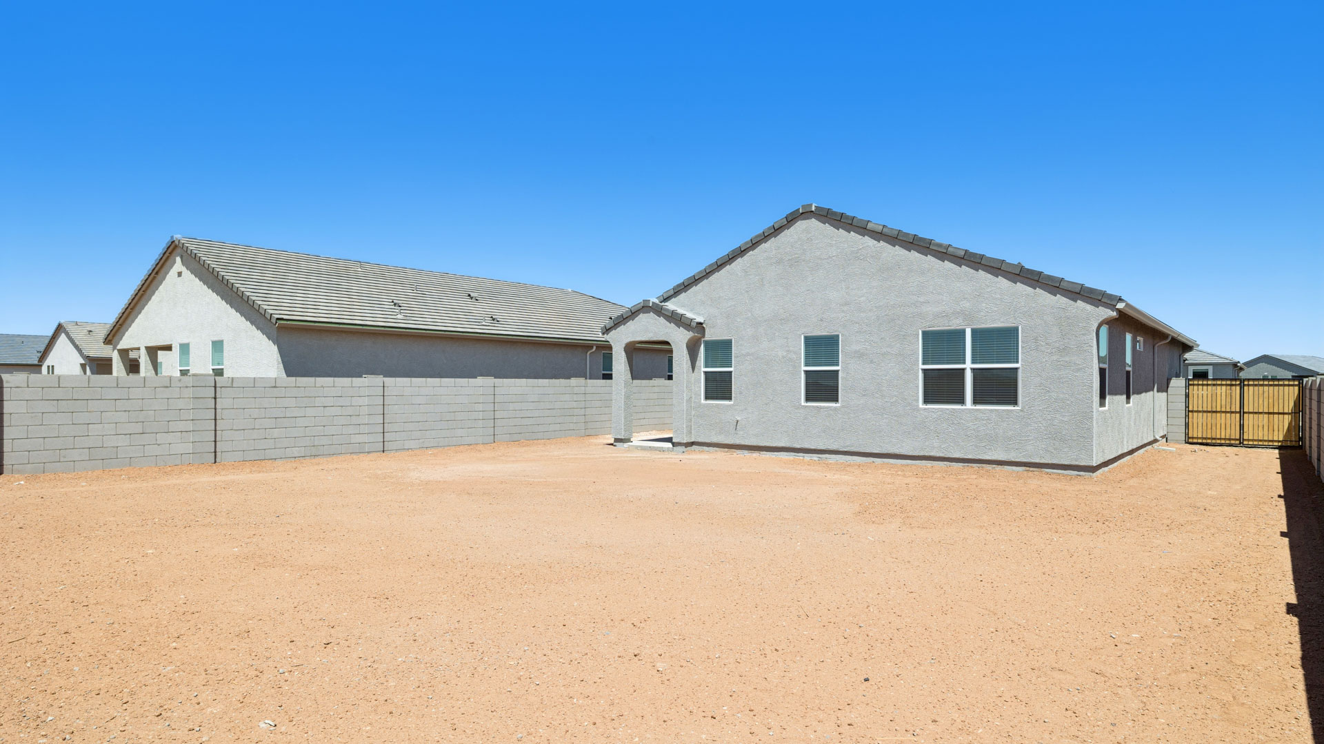 Large fenced-in backyard with a covered patio, perfect for outdoor entertaining.