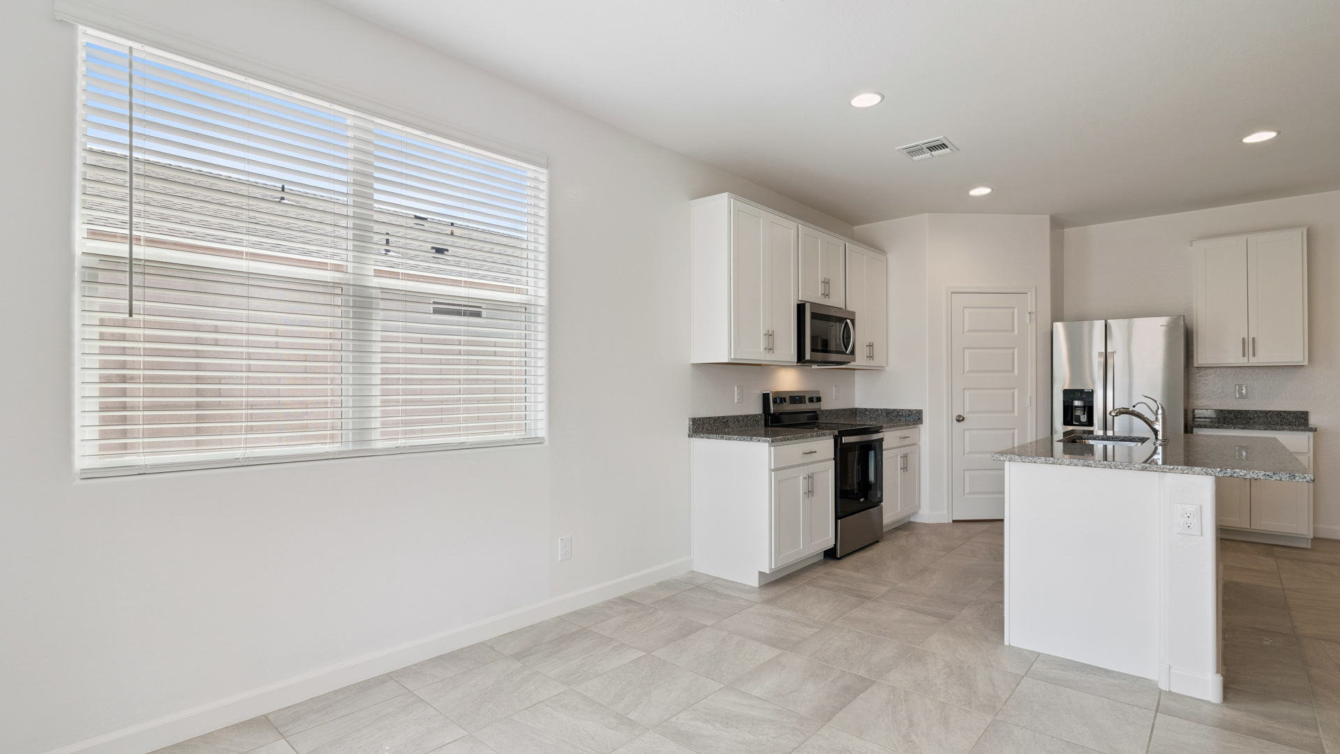 A well-organized living room that includes a kitchen and dining area, creating a warm and welcoming environment for gatherings.