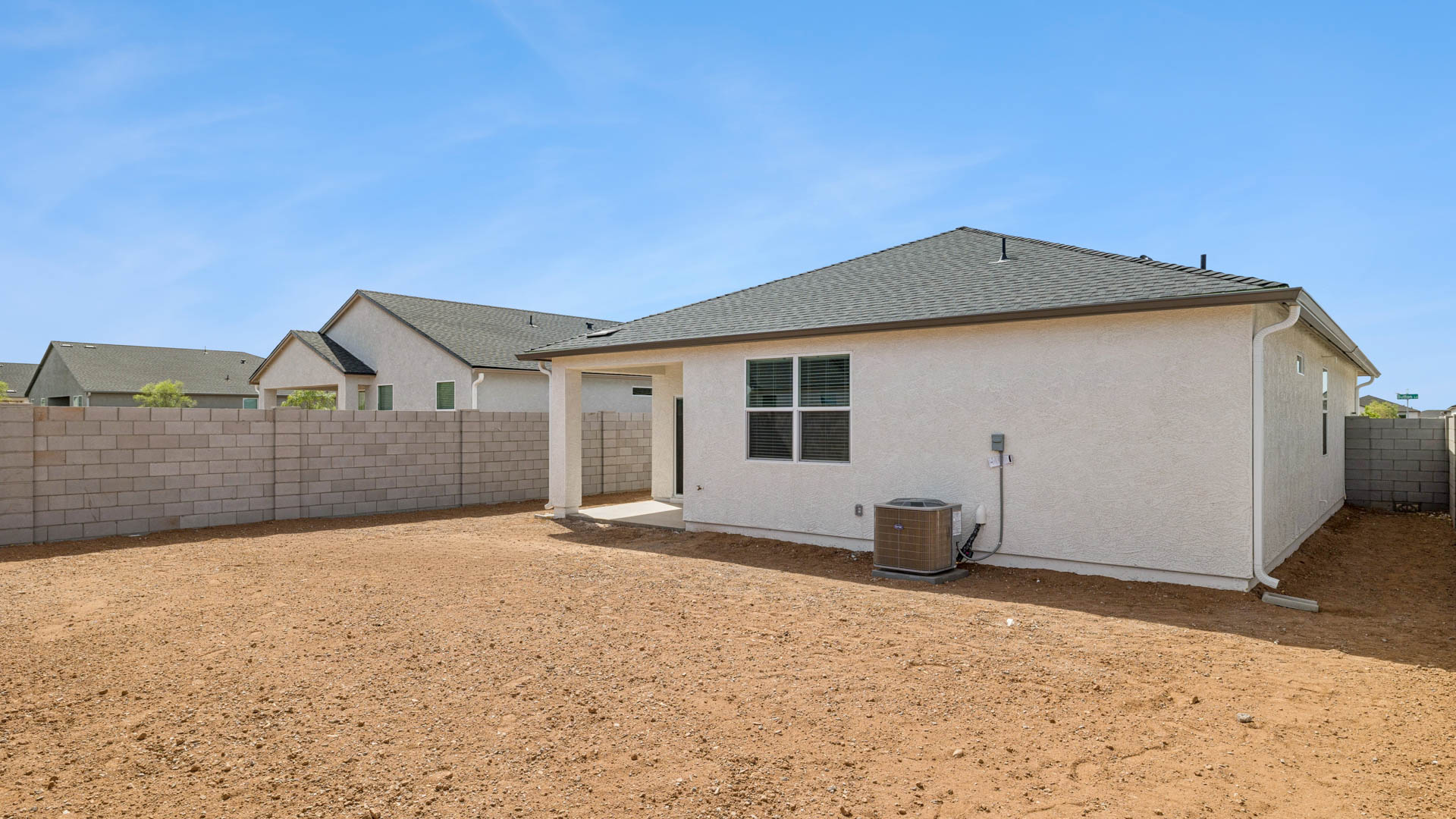 Large fenced-in backyard with a covered patio, perfect for outdoor entertaining.