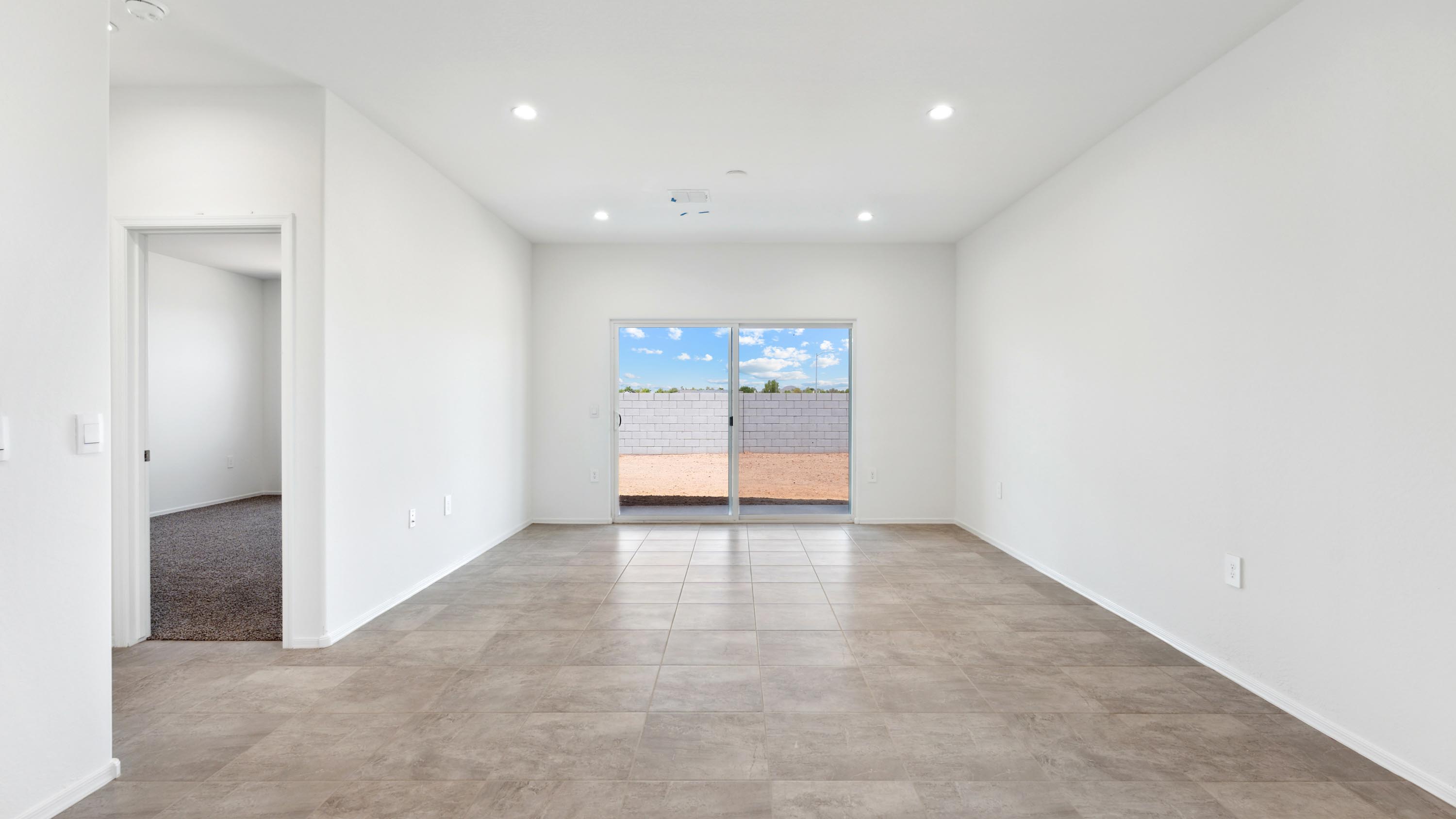 A well-organized living room that includes a kitchen and dining area, creating a warm and welcoming environment for gatherings.