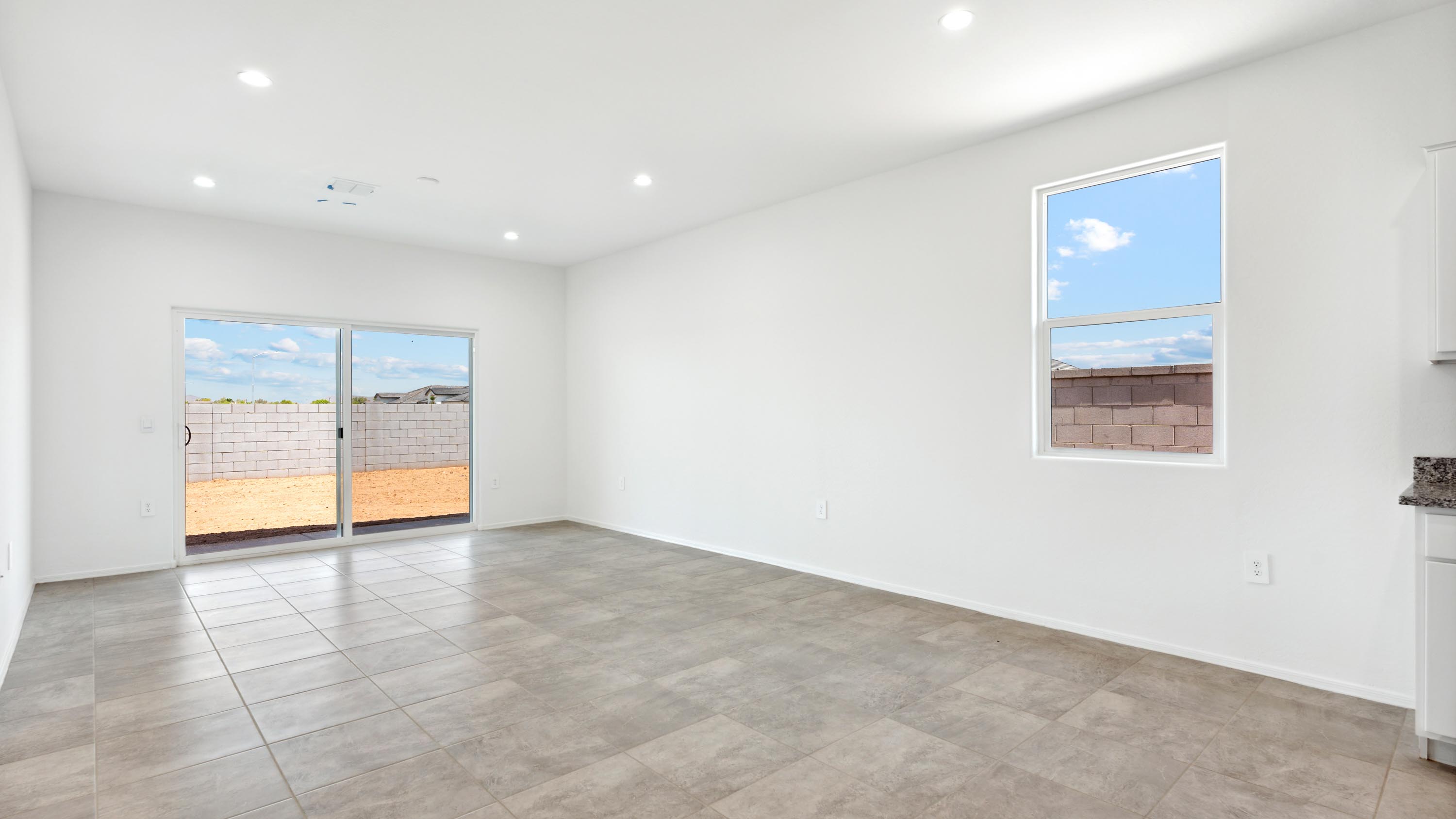 A well-organized living room that includes a kitchen and dining area, creating a warm and welcoming environment for gatherings.
