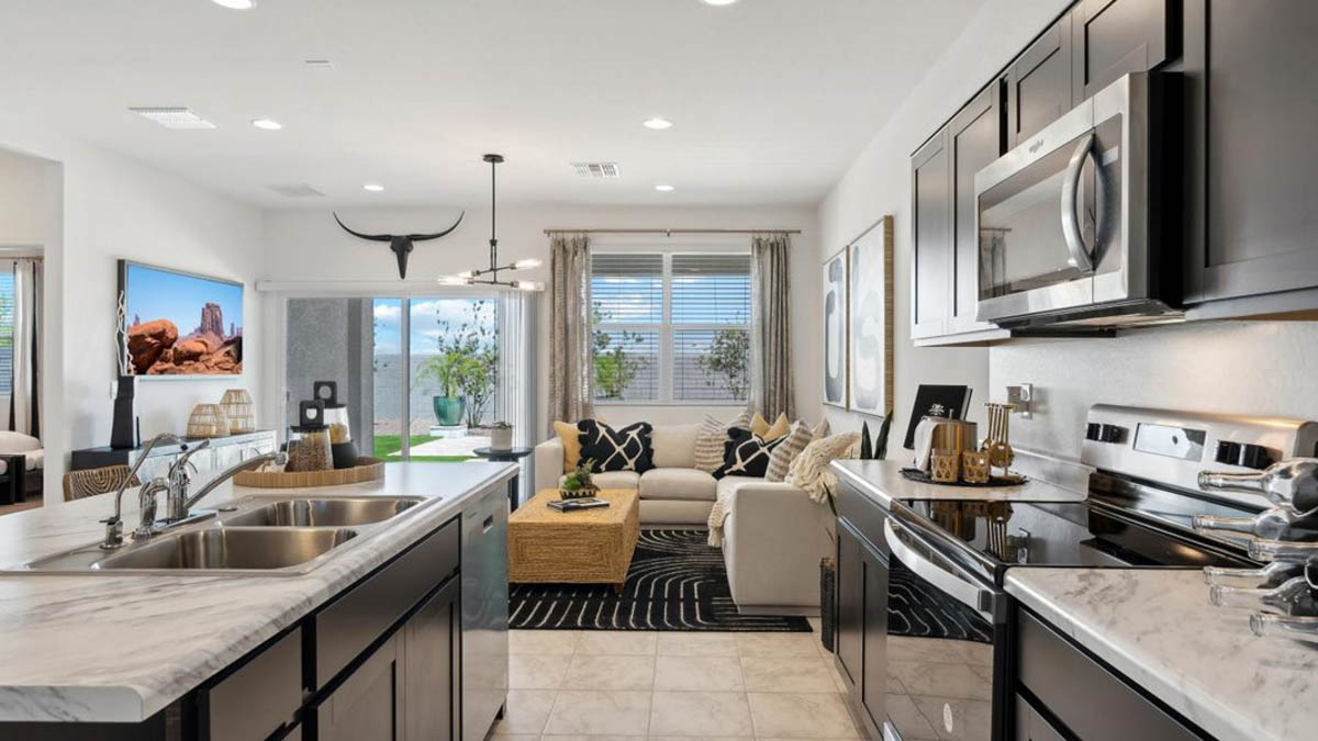 Bright and spacious kitchen with porcelain countertops, stainless steel appliances, and an island with bar seating.