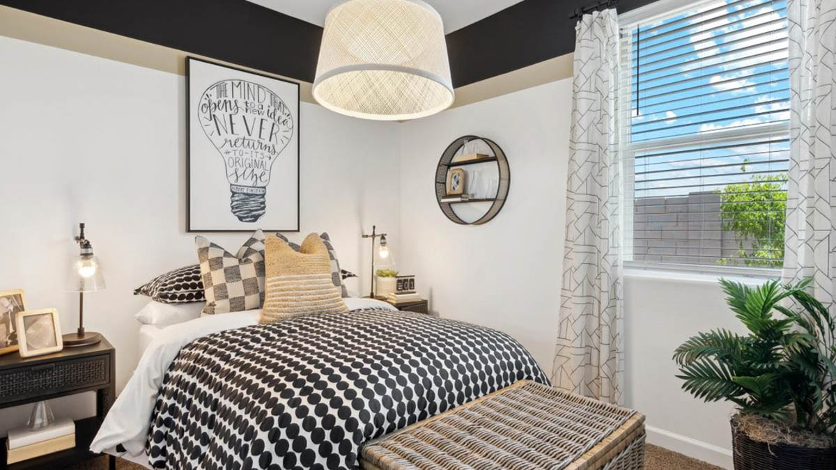 Comfortable guest bedroom featuring neutral-toned walls and a large closet.