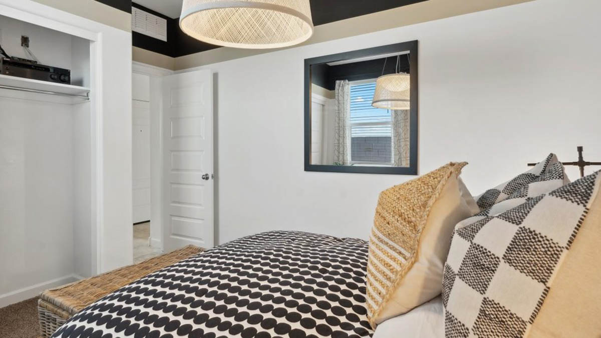 Comfortable guest bedroom featuring neutral-toned walls and a large closet.