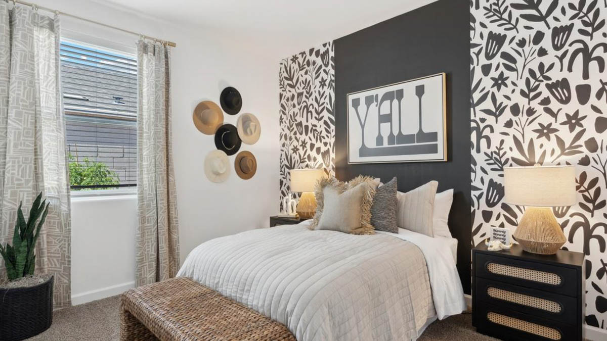 Comfortable guest bedroom featuring neutral-toned walls and a large closet.