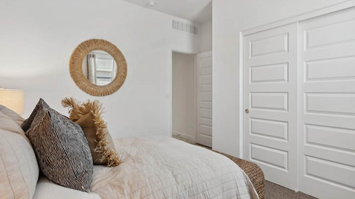 Comfortable guest bedroom featuring neutral-toned walls and a large closet.