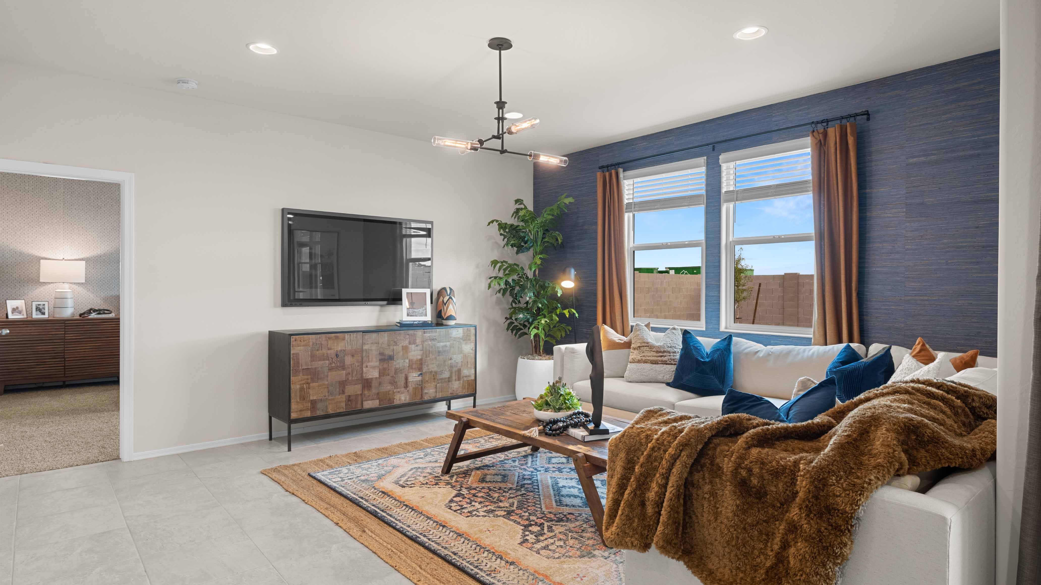 A well-organized living room that includes a kitchen and dining area, creating a warm and welcoming environment for gatherings.