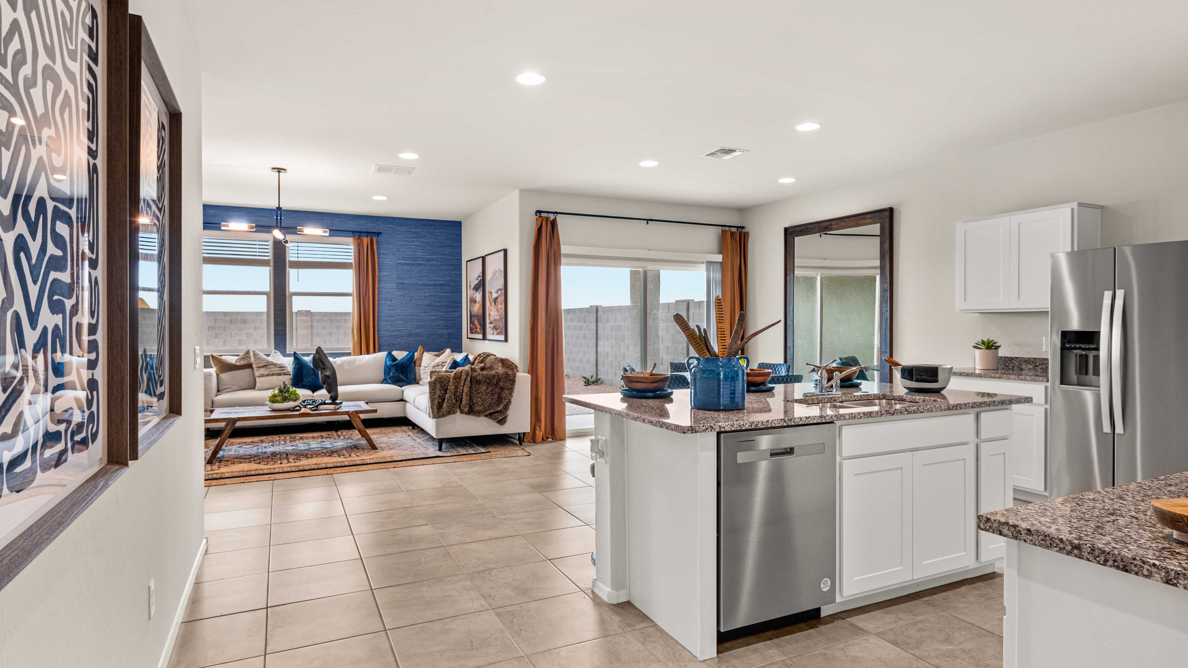 Bright and spacious kitchen with granite countertops, stainless steel appliances, and an island with bar seating.