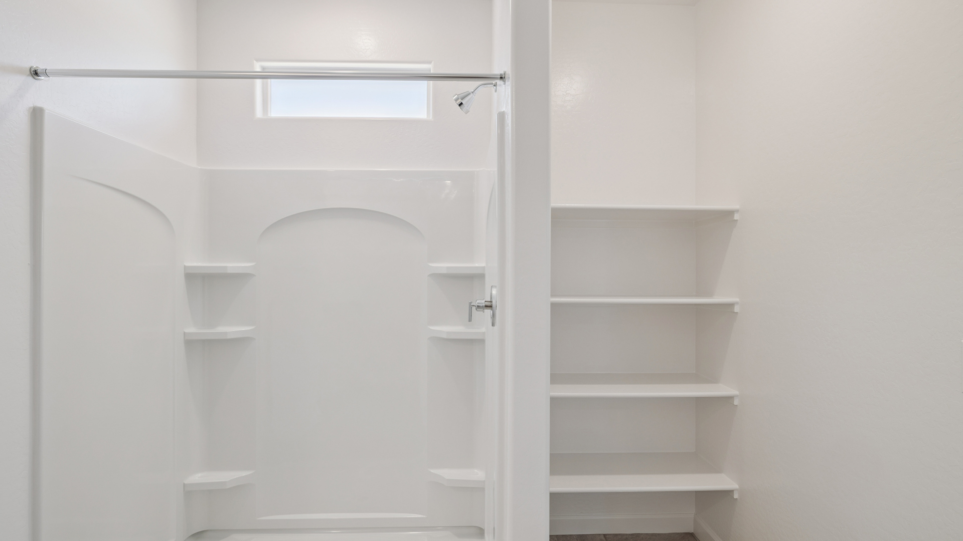 Modern primary bathroom with double vanity, granite countertops with a walk-in shower and a walk-in closet.