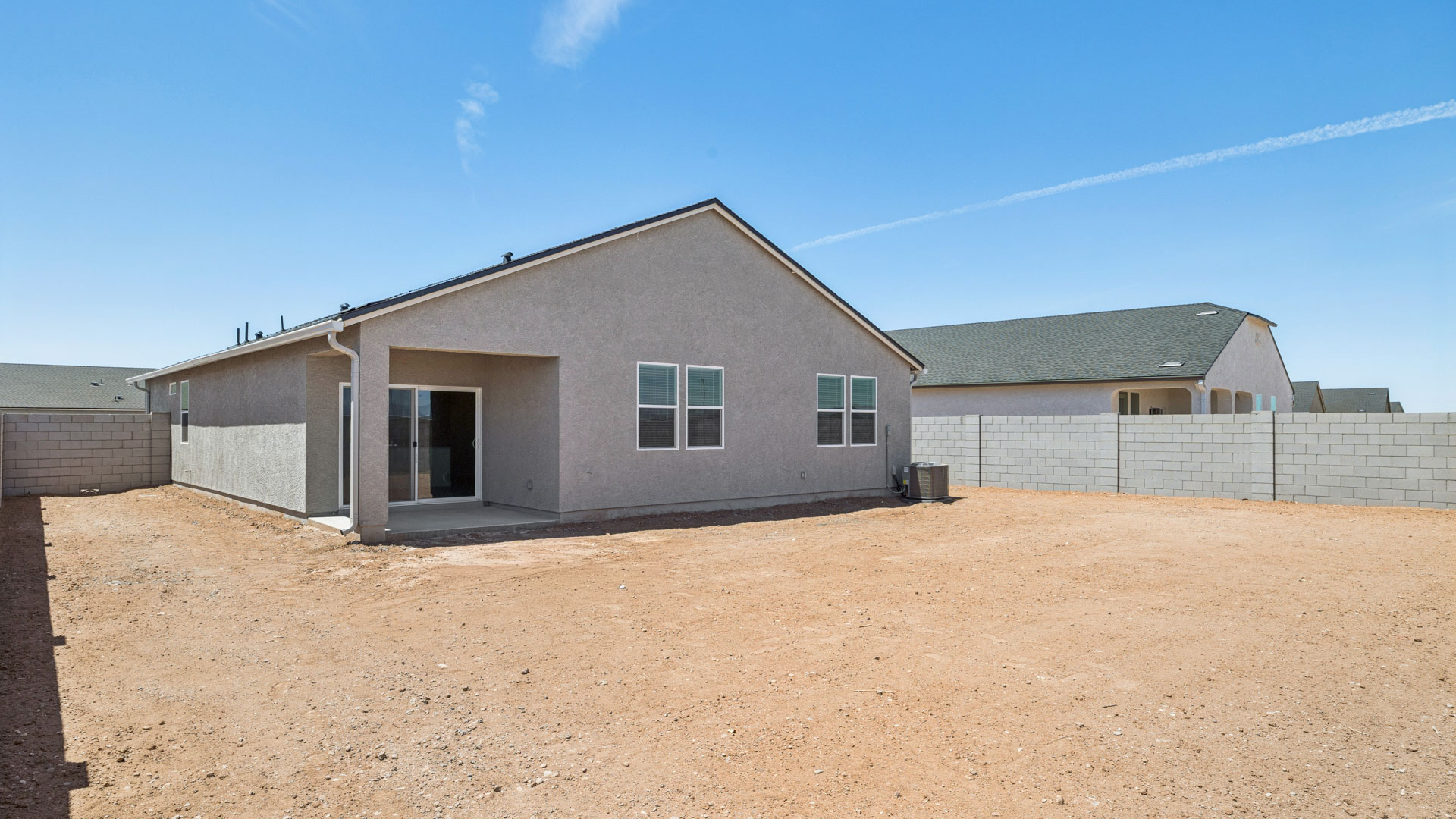 Large fenced-in backyard with a covered patio, perfect for outdoor entertainment.