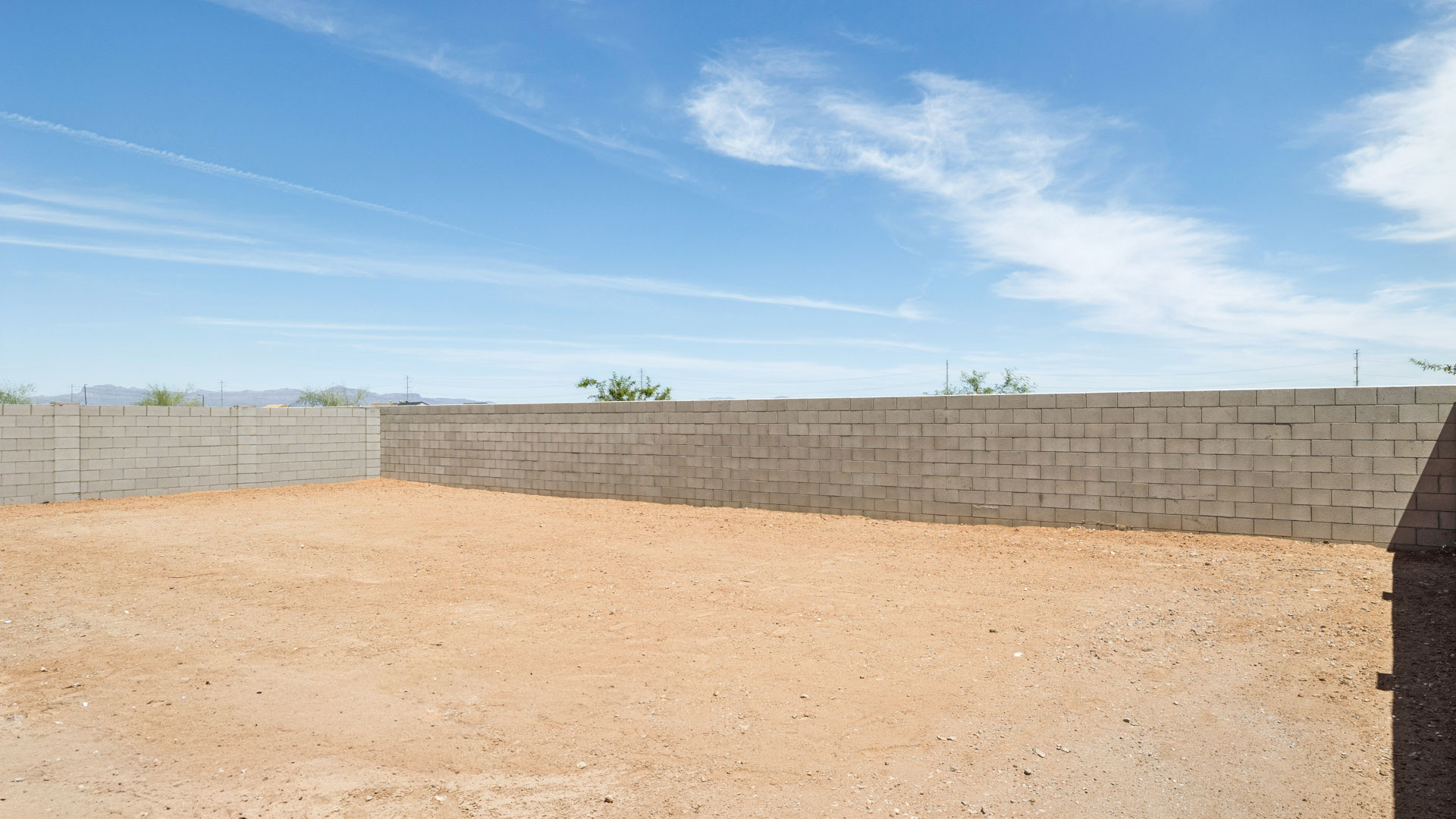 Large fenced-in backyard with a covered patio, perfect for outdoor entertainment.
