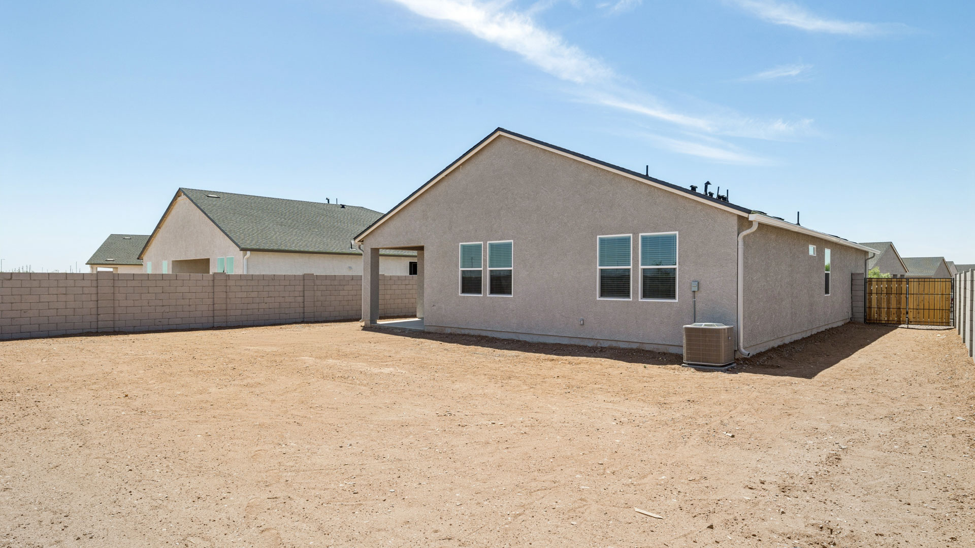 Large fenced-in backyard with a covered patio, perfect for outdoor entertainment.